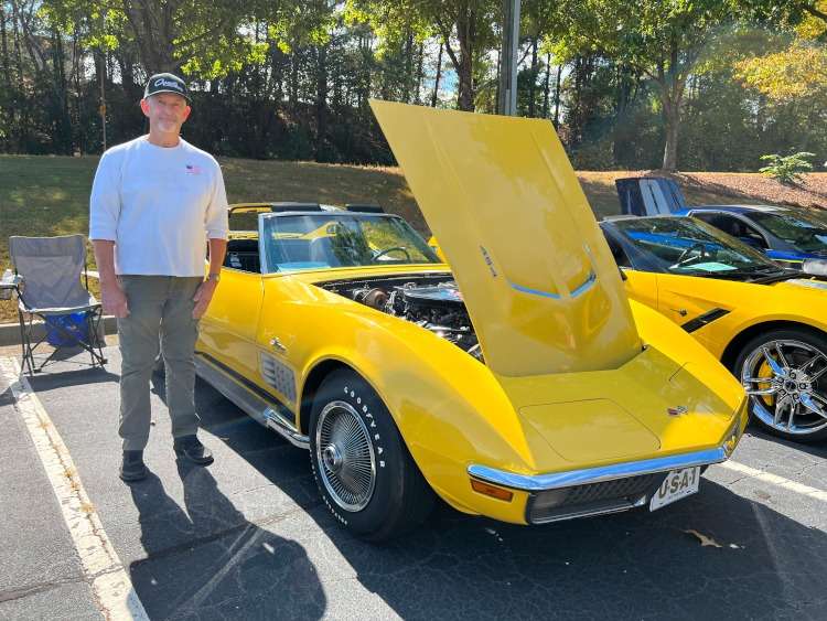 Second-generation yellow Corvette coupe with side pipes.
