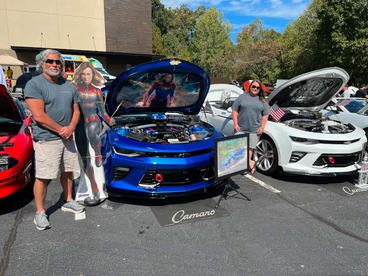 Two themed custom Camaros at car show