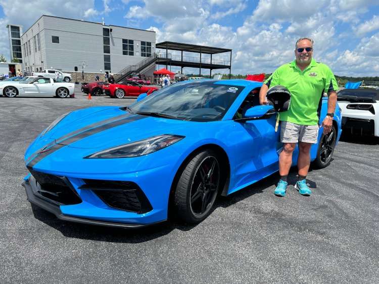 A blue eighth-generation blue Corvette with a racing stripe.