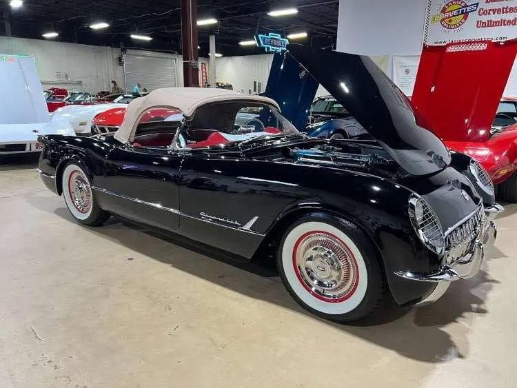 Side view of a black 1954 Corvette.