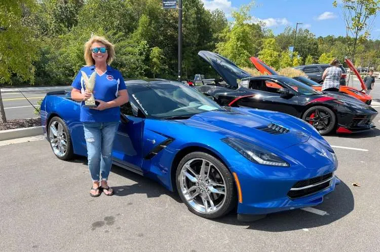 A blue 2014 Corvette coupe at a car show.