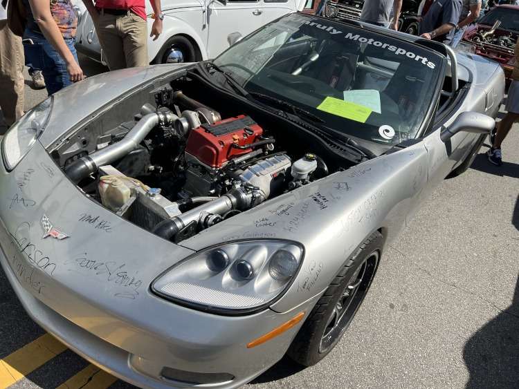 Looking down at a Honda engine inside a Corvette.