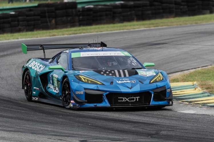 The blue and green #36 DXDT Racing Corvette Z06 GT3.R navigating a tight corner at VIR.