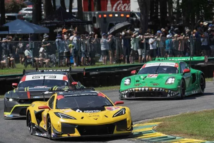 The #3 Corvette Z06 GT3.R leads the Ford Mustang and "Rexy" Porsche in a crowded corner at VIR.