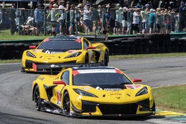 Close-up of the #3 and #4 Corvette Z06 GT3.R race cars at VIR, running in formation during the race.