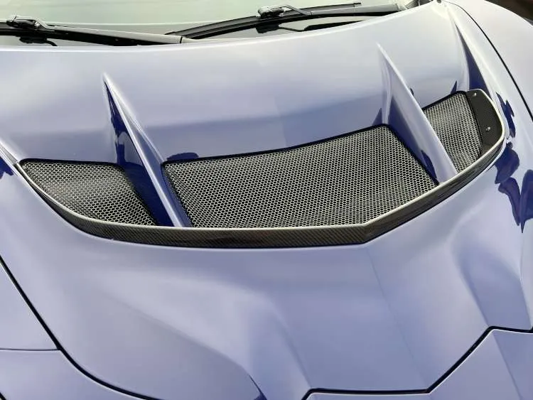 Close-up overhead view of the carbon fiber hood extractors and frunk air exchanger on a Hysteria Purple 2025 Corvette ZR1.