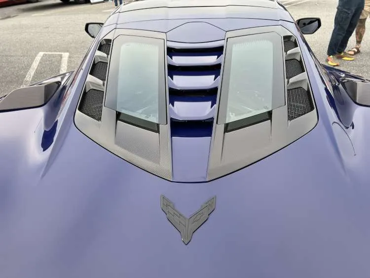 Overhead view of the 2025 Corvette ZR1 split rear window design on a Hysteria Purple coupe, featuring carbon fiber venting and heat extractors.