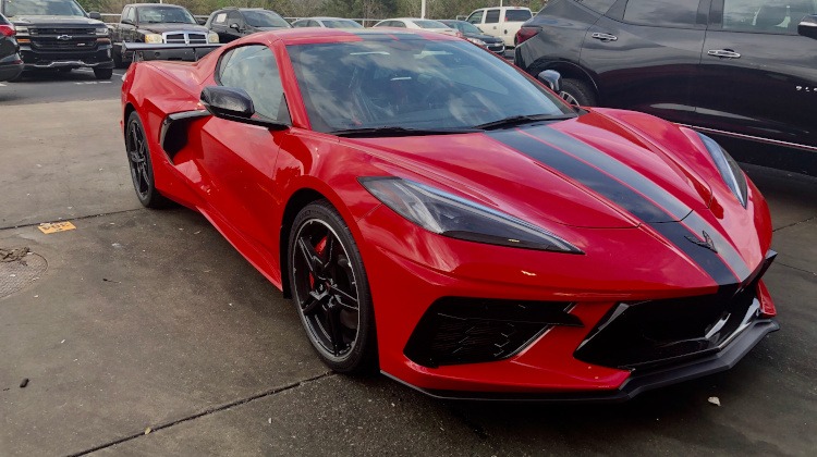 C8 Corvette coupe in Torch Red with black racing stripes