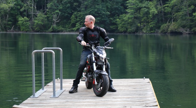 Darryl "Killboy" Cannon on a dock pier sitting on a motorcycle
