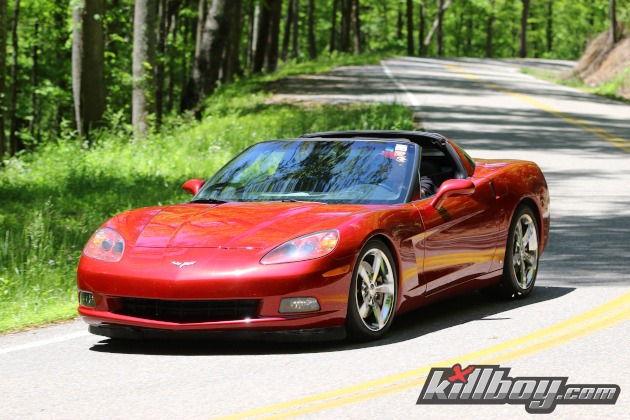 Sixth-generation Torch red Corvette driving on a twisty road
