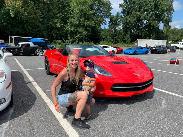 Woman and child beside a seventh-generation Corvette