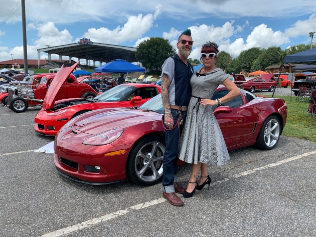 Two people by a 2013 C6 Corvette