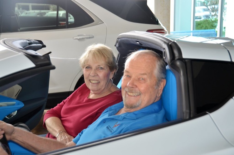 A couple sitting in the eight-generation Corvette