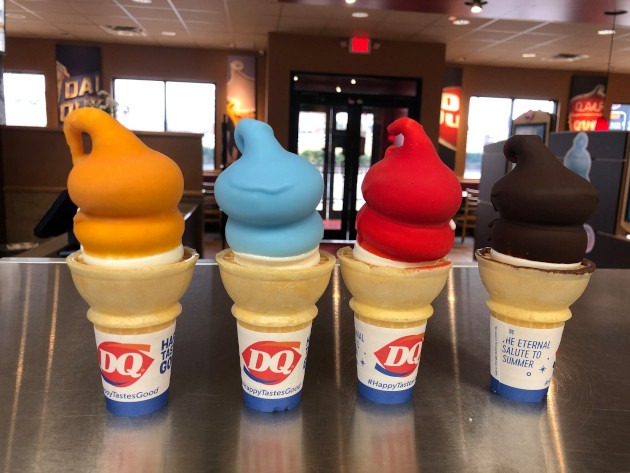 four flavors of dipped icecream in cones