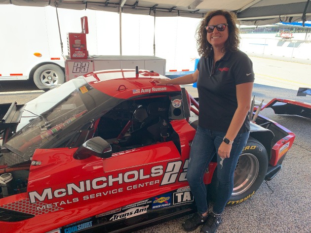 Amy Ruman beside her Corvette race car