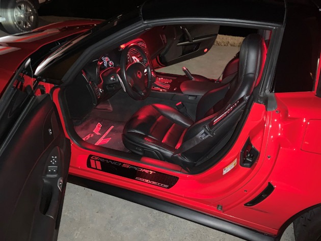 Red lights inside a Torch Red Grand Sport Corvette