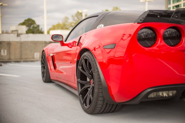 Back side view of a Torch Red Grand Sport Corvette