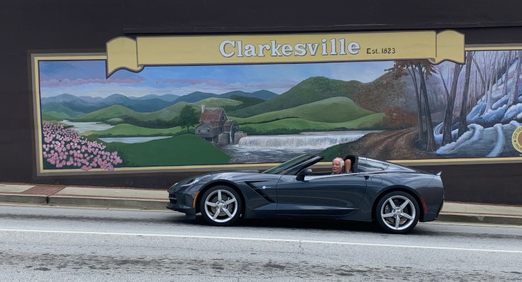 Seventh-generation Gray Corvette beside a mural for Clarkesville, GA.