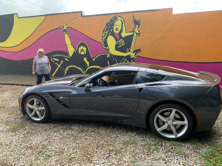 Seventh-generation Corvette in front of a rock and roll wall mural