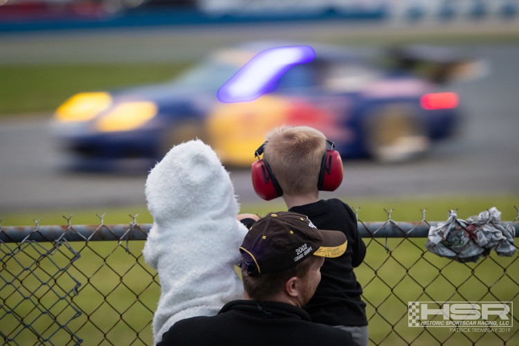 Two small people and their father watching HSR racing