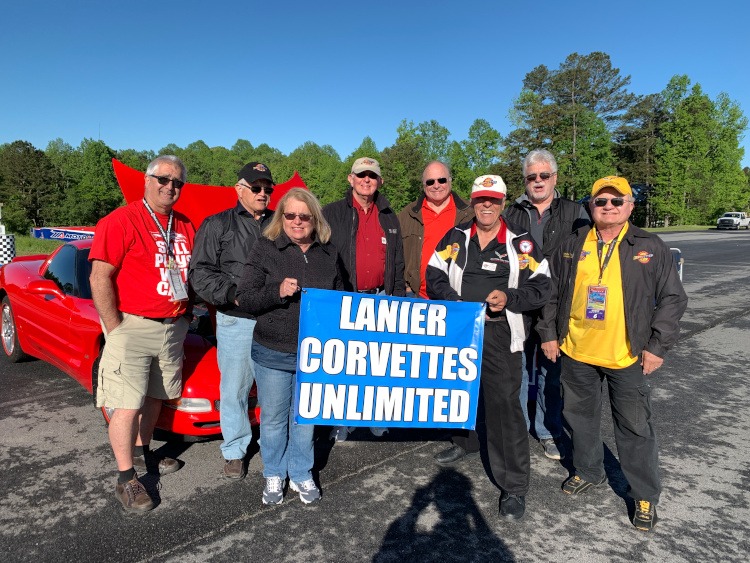 Members hold Lanier Corvettes Unlimited banner