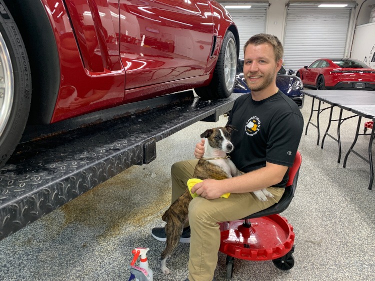 Tiaan the owner of AP3 paint protection business with his shop dog