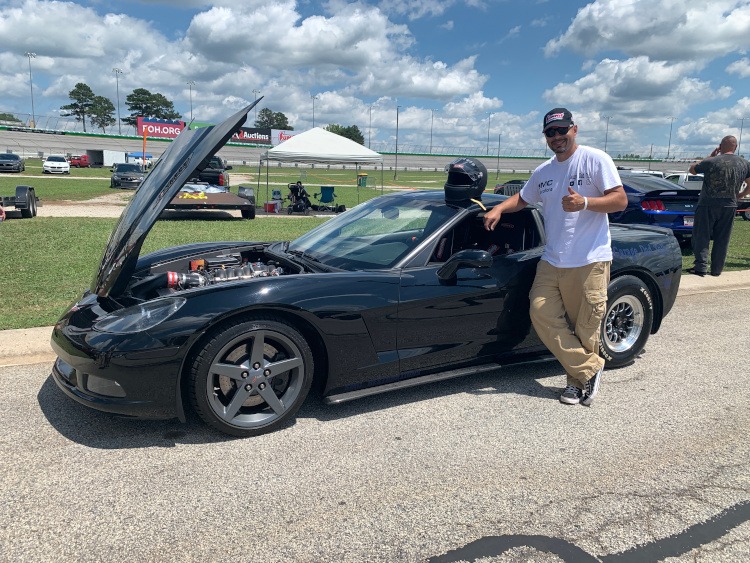 Sixth-generation Black Corvette coupe at the race track