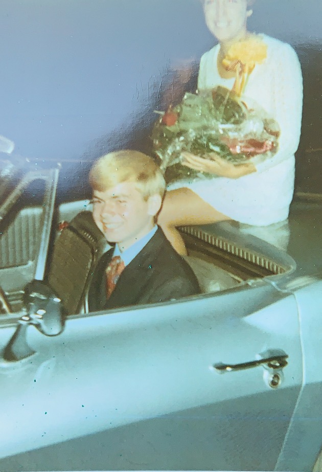 Young man driving a 1964 silver blue Corvette