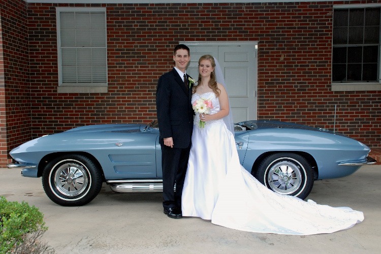Bride and Groom in front of a silver-blue Corvette roadster