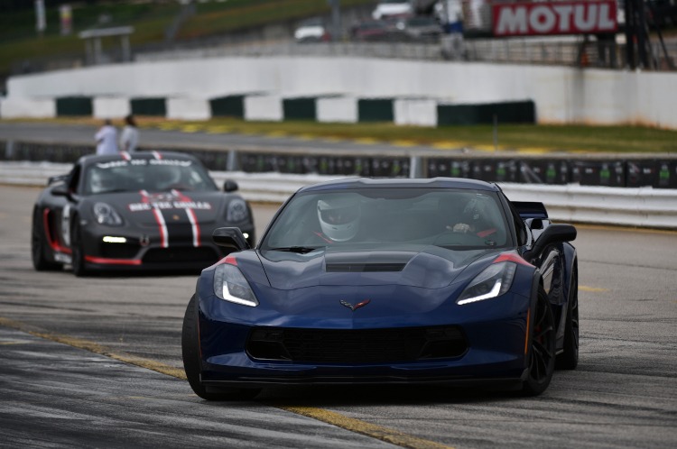 A seventh-generation Corvette on the track with a Porsche