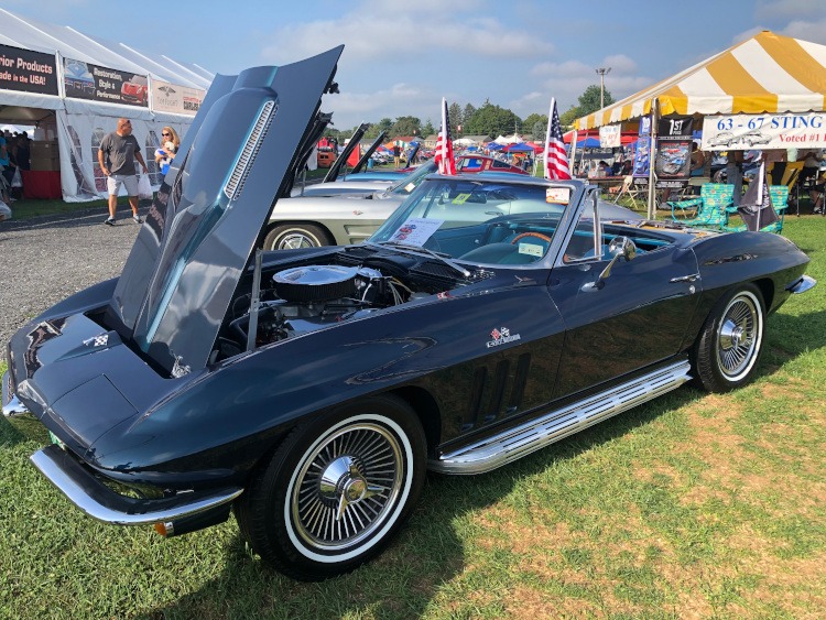 Mid-year Corvette roadster in black parked outside