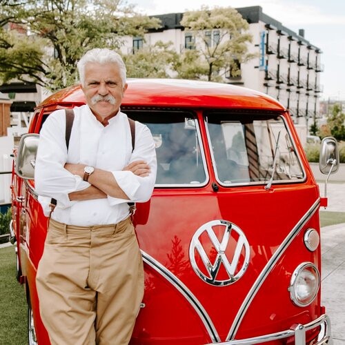 Corky Coker leaning against a VW bus