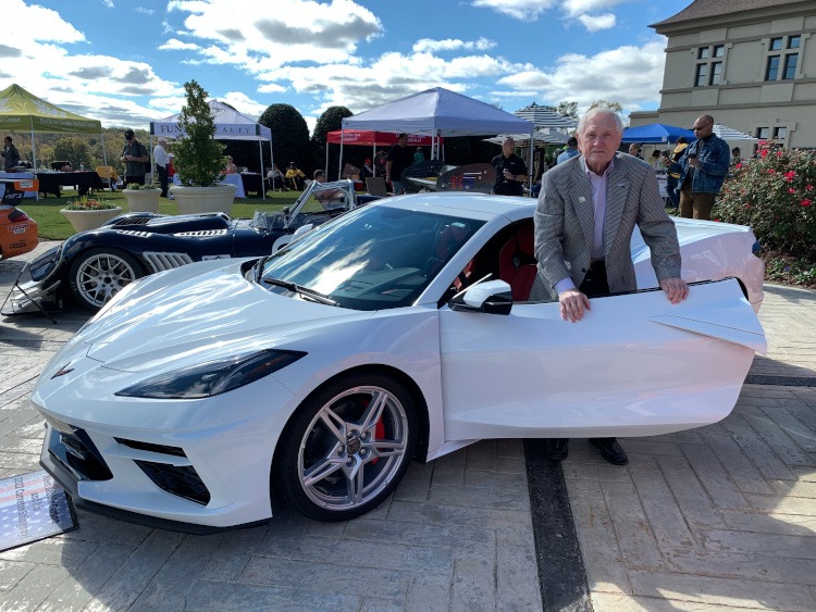 Man standing beside a 2022 C8 Arctic White Corvette