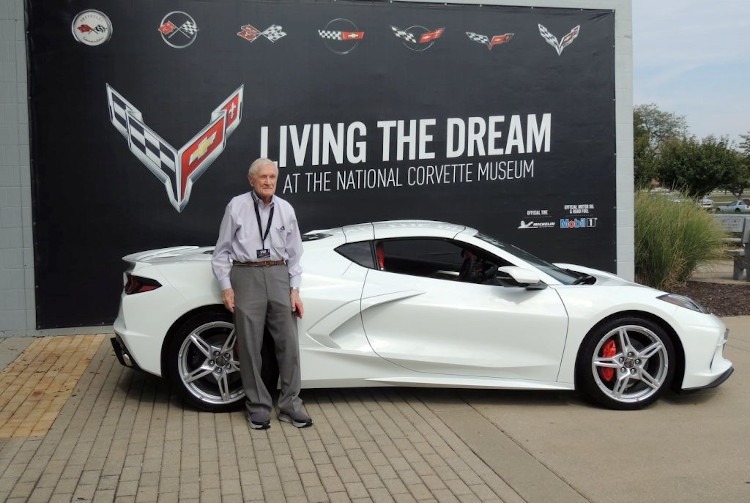 Man standing beside a 2022 C8 Arctic White Corvette