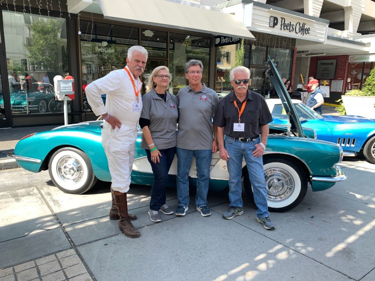 First-generation Turquoise colored Corvette roadster with owner and friends
