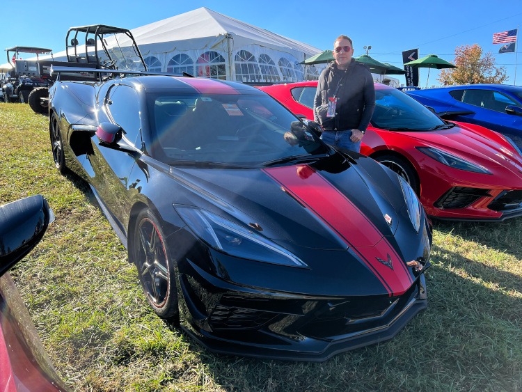 Eighth-generation Corvette coupe in black with a red racing stripe