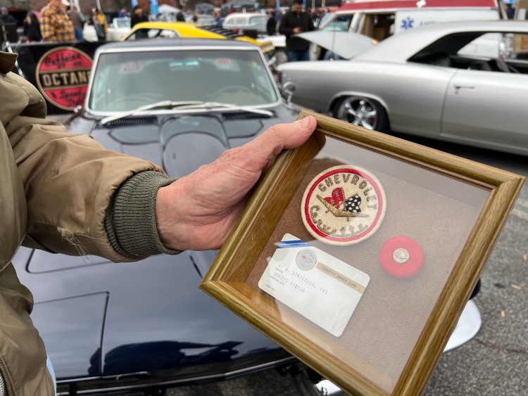 Corvette owners card and patch in a display case