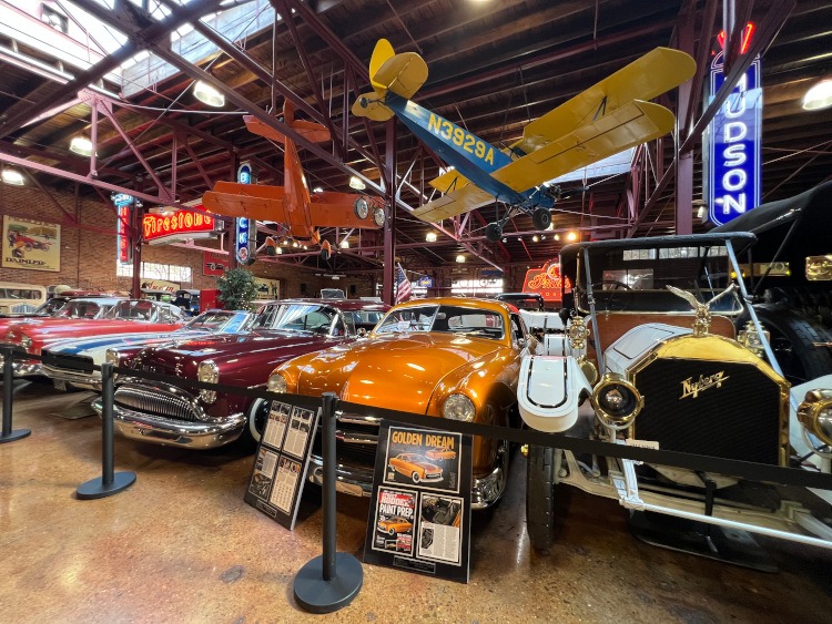 Classic cars and an airplane hanging from the ceiling at the Coker Museum