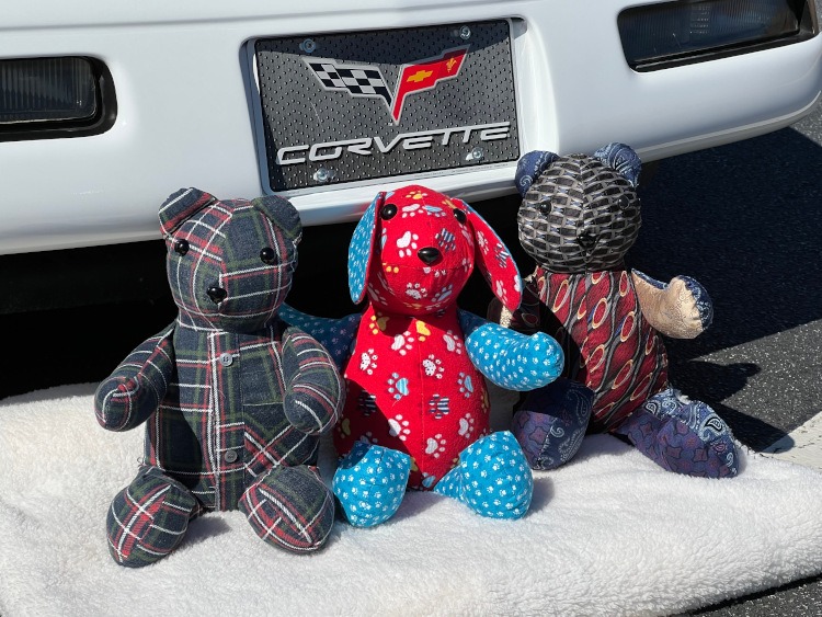 Stuffed comfort animals at the front bumper of a 1994 Arctic White Corvette