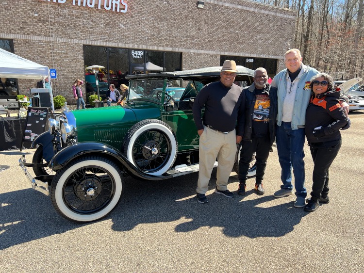 People standing beside a green Model A