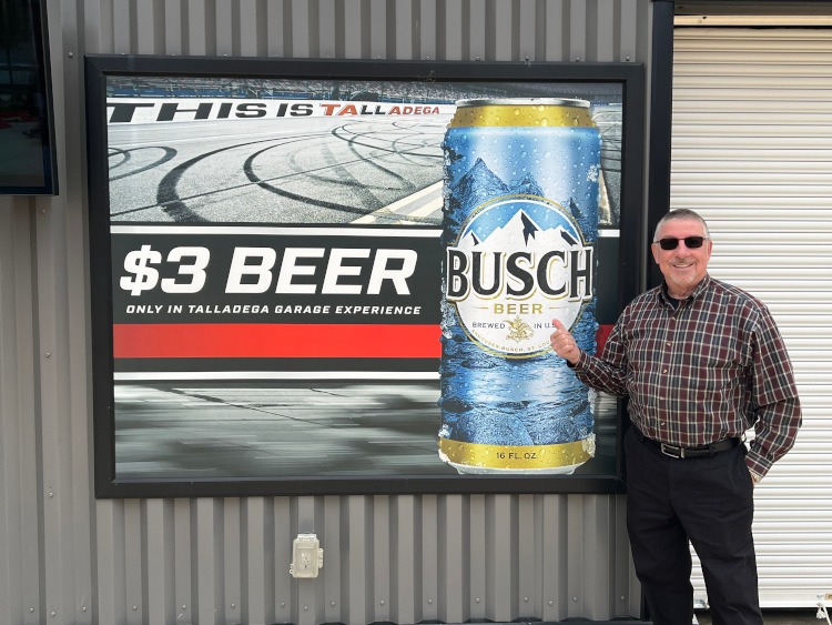 Man in front of a Busch beer sign at Talladega Superspeedway