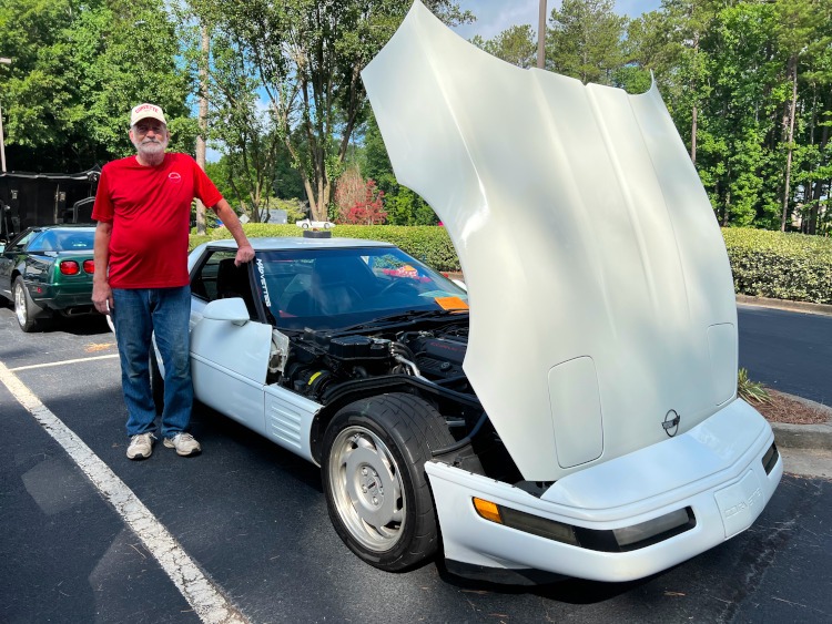 Fourth-generation White Corvette coupe with clam shell hood