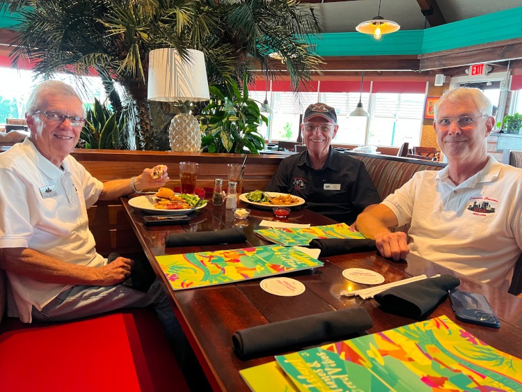 Three men having dinner at a restaurant