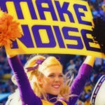 LSU cheerleader holding a sign to make noise