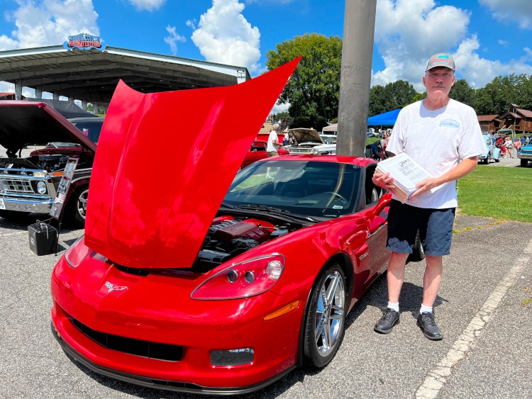 Man passing out advertisements at a car show
