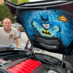 Airbrush artist standing beside Batman hoodliner