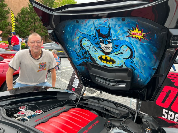 Airbrush artist standing beside Batman hoodliner