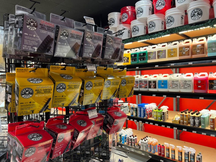 Various car cleaning supplies on shelves.