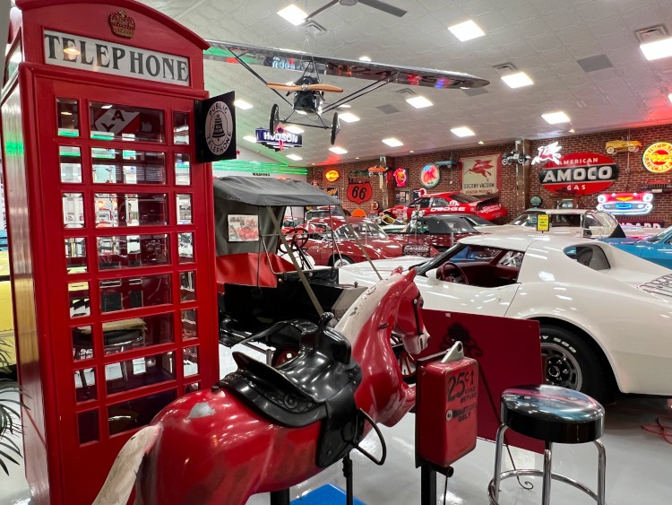 Vintage phone booth and cars at a car museum in Summerville, Ga.