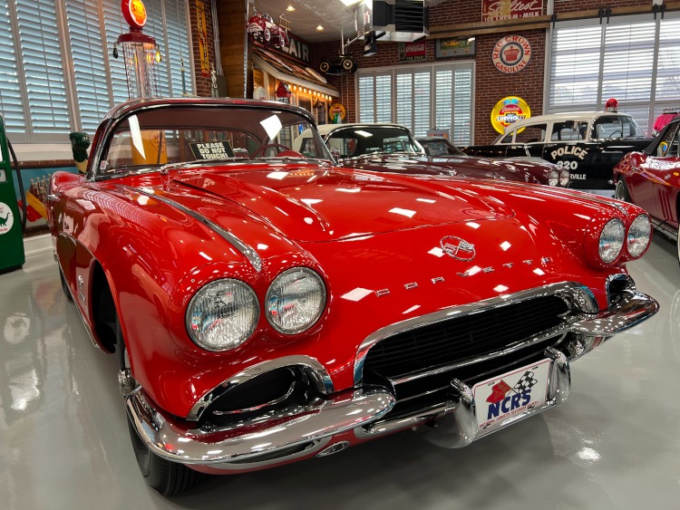 The front end of a red C1 Corvette in a museum.